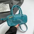 Glossy teal jelly handbag in candy color with gold hardware and shoulder strap - Blue