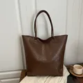 Deep brown large tote bag featuring a woven texture and dual shoulder straps - Brown