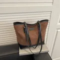 Brown quilted tote bag with black trim and contrast stitching for a stylish casual look - Brown