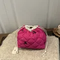 Magenta quilted drawstring storage pouch featuring elegant black embroidered bows - Rose Pink