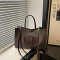 Brown monogram tote bag with embossed M logo and long shoulder straps for women - Brown