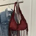Bohemian burgundy faux suede shoulder bag featuring long fringe and drawstring details - One Size / Burgundy