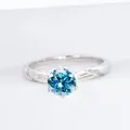 Elegant twisted S925 silver ring featuring a 1-carat round blue moissanite in 6-prong setting - Aqua