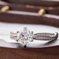 Detail of six-prong moissanite ring with double-row micro-pave diamonds on silver band - HK Size 9 / 0.5 ct