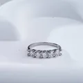 Macro shot of 925 sterling silver band with five round-cut moissanite stones and 925 hallmark - US 5 / White (With GRA Certificate)