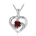 Detail view of heart-shaped silver necklace with red gemstone and white accents - 925 Silver / Silver Garnet Red