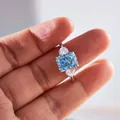 Macro shot of 3-carat radiant-cut blue gem ring with pear-shaped side diamonds - Size 5 / Sky Blue Radiant Cut (3 Carat)