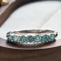Macro shot of s925 silver ring featuring seven round-cut light blue moissanite stones - US 5 / Blue