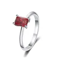 Macro view of emerald cut red ruby gemstone set in 925 sterling silver four-prong ring - US 5 / Garnet Red