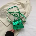 Mini green crocodile pattern handbag with metallic finish and top handle for women - Green