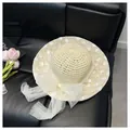 Large woven beach tote bag featuring white floral lace embroidery and a sheer tulle bow - Hat