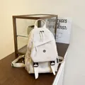 Cream white minimalist oxford cloth backpack with utility pockets and buckle details - White