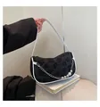 Elegant black floral woven crescent bag with white leather trim and pearl chain detail - Black