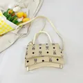 Chic beige bucket bag featuring black bear prints and a unique curved base design - Beige White Large