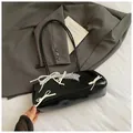 Black glossy baguette bag featuring lace trim, pearls, and 3D bows for women - Black With Pendant