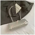 Metallic silver baguette bag with pink bows and slim straps on a white background - Silver No Pendant