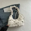 Cream plaid crescent bag featuring ruffled straps and bow accents for casual wear - Khaki