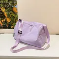 Minimalist lavender nylon crossbody bag with adjustable strap and spacious interior - Purple