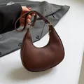 Dark brown crescent moon shoulder bag in premium lychee texture leather finish - Brown