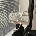 Elegant beige faux leather underarm bag with crocodile embossed texture and gold hardware - White