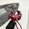 Burgundy half-moon handbag with silver ball studs and adjustable shoulder strap - Red