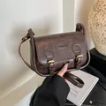 Retro dark coffee PU saddle bag with decorative straps and golden buckles - Coffee