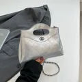 Silver quilted metallic handbag with chain strap and dual-ring logo in modern style - Silver