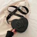 Fashionable black heart-shaped crossbody bag with 3D SM logo and wide nylon strap - Black