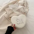 Cream heart-shaped crossbody bag with SM logo and wide adjustable shoulder strap - White