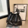 Black ruched cloud tote bag with silver bow accent and glossy PU leather finish - Black