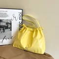 Bright yellow pleated shoulder bag with silver bow and drawstring closure - Yellow