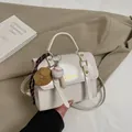 Creamy white glossy briefcase handbag with baseball charm and fashion gold lettering detail - With Pendant / White