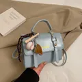 Light blue glossy crossbody briefcase with gold buckles and baseball keychain - With Pendant / Blue