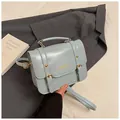 Light blue-grey messenger handbag with gold FASHION text and vintage buckle detail - Blue