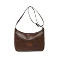 Classic dark brown leather shoulder bag with fashion label on a white background - Brown