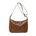 Retro dark brown crossbody bag with fashion tag on a minimalist white background - Brown