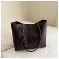 Detail view of deep brown PU leather tote bag with vertical stitching on white fabric - Coffee
