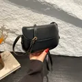 Minimalist black leather saddle crossbody bag with adjustable golden metal buckle strap - Black