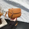 Vintage brown matte leather saddle bag with adjustable strap and golden buckle detail - Brown