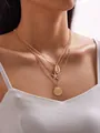 Three-layer gold necklace with shell and starfish charms on a model for beach fashion - Gold 3-Layer Layered Shell Starfish Necklace (7105-gold)