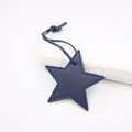 Detail of dark blue star-shaped PU leather pendant with lychee texture and stitching - Star Lanyard / Navy Blue
