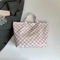 Pink and white checkered tote bag with top handles and printed text on a clean surface - Tote Bag / Pink Checkerboard