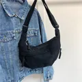 Black corduroy crescent crossbody bag with adjustable strap and striped texture details - Black