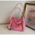 Detailed side view of pink fluffy shoulder bag with cute white bear charm and long straps - With Charm / Pink