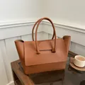 Minimalist caramel brown leather tote bag with unique geometric handles for women - Caramel color