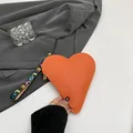 Orange heart-shaped coin purse with litchi texture and LOVE printed hand strap - Orange