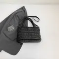 Chic black quilted puffer handbag with top handles and adjustable strap for winter fashion - Black