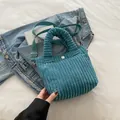 Lake blue corduroy handbag featuring pleated handle and detachable woven shoulder strap - Teal