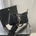 Chic black quilted shoulder bag featuring gold SGS logo and elegant fringe tassel - Black