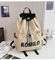 Close-up of lightweight nylon drawstring backpack with adjustable straps and front pocket - Large / Single Bag / Off White